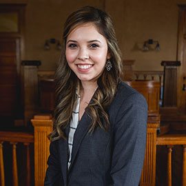 divorce lawyer with grey suit smiling long hair