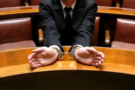 hand cuffed man wearing a suit