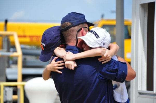 Foster parent hugging kids